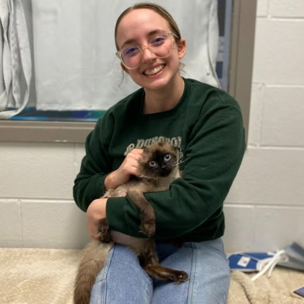 smiling girl with a cat in her arms