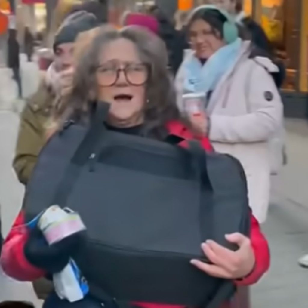 smiling woman carrying a black bag