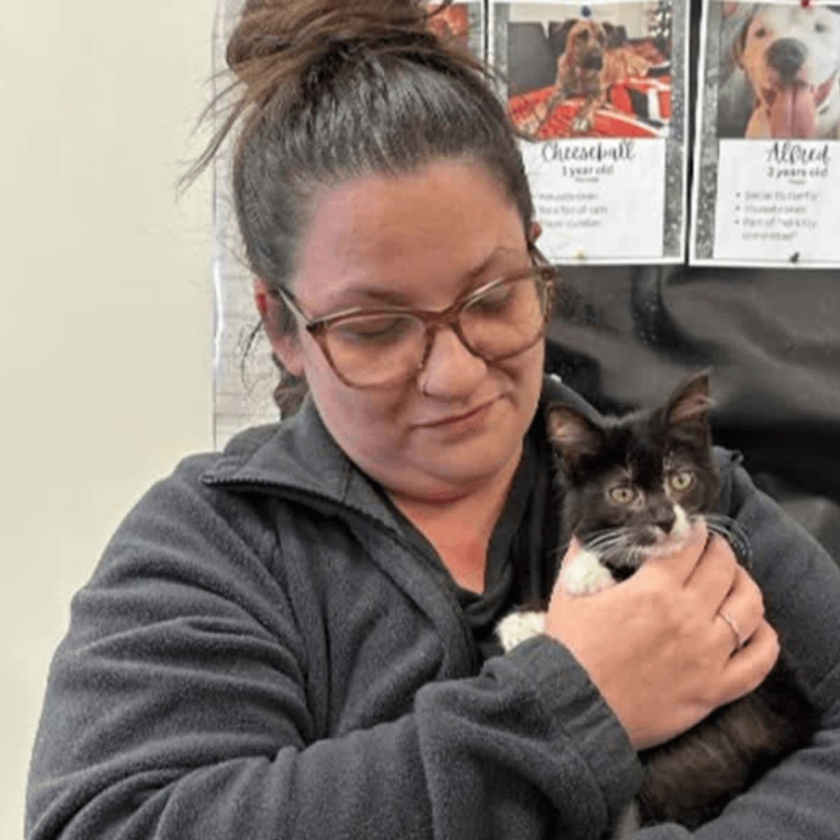 woman holding a black kitten