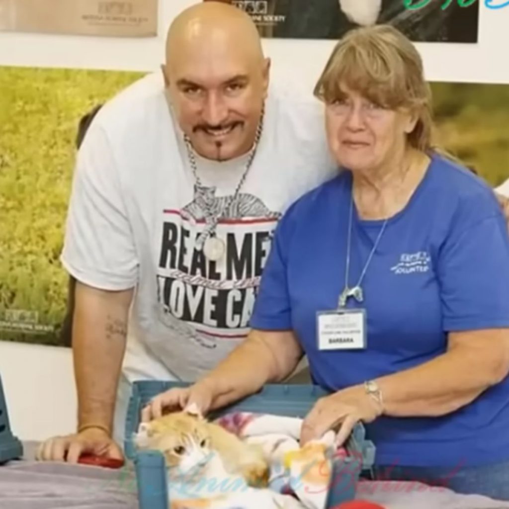 a man and a woman with a cat