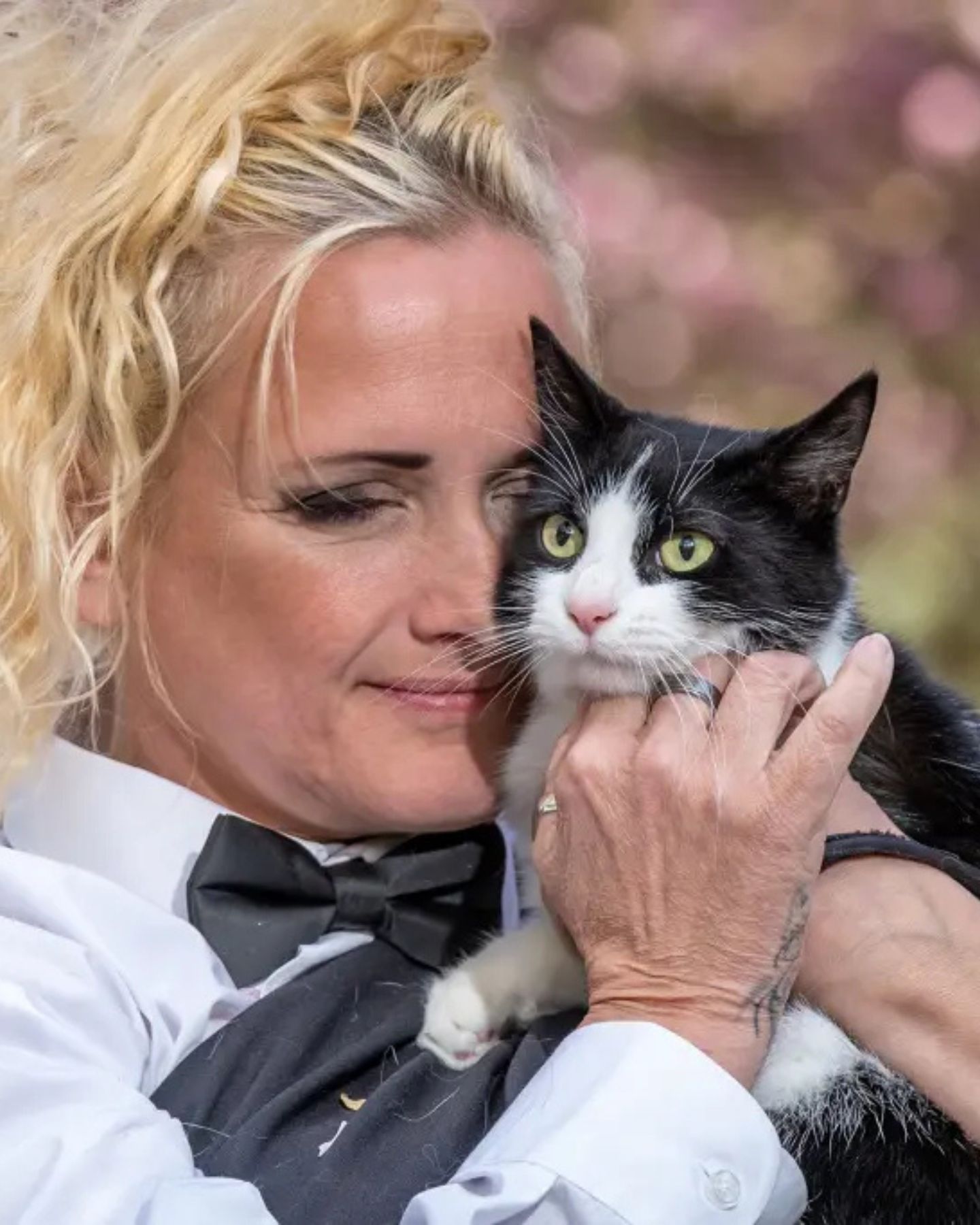 blonde woman hugging a cat