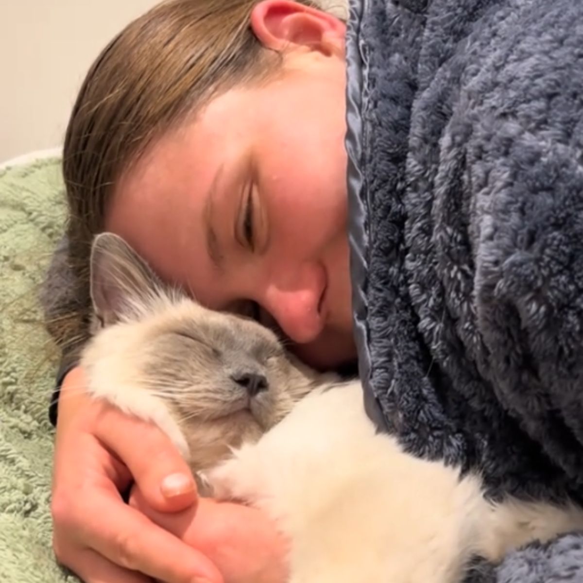 woman sleeping with ragdoll cat