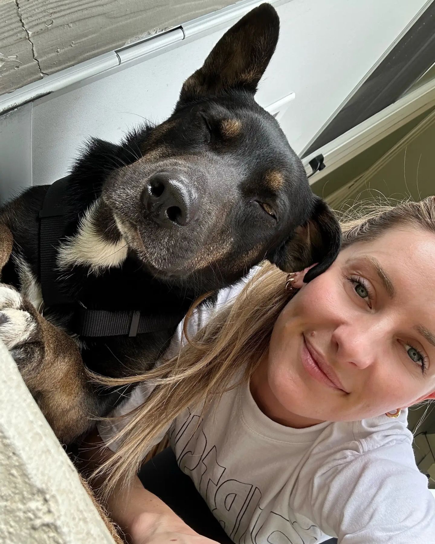 blonde woman and black dog