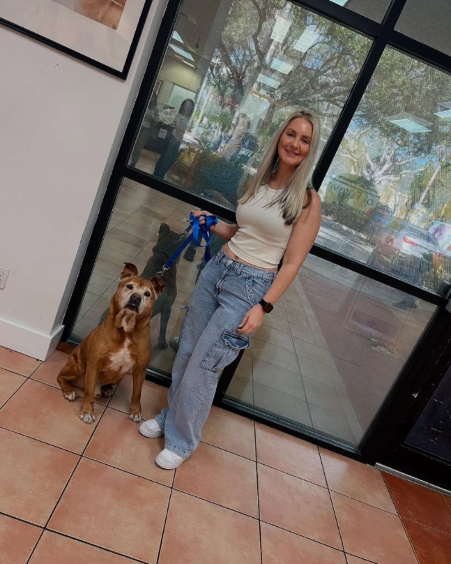 blonde woman and brown dog