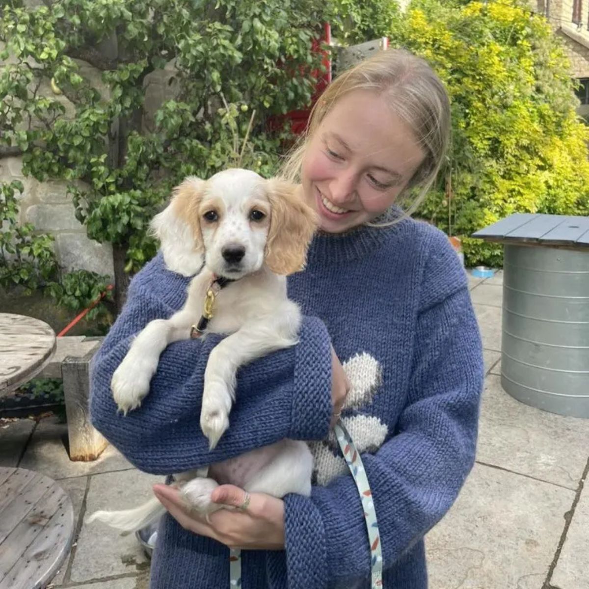 blonde woman holding a dog