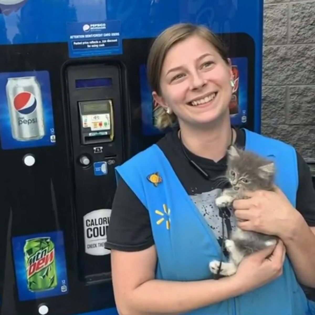 happy woman holding a kitten