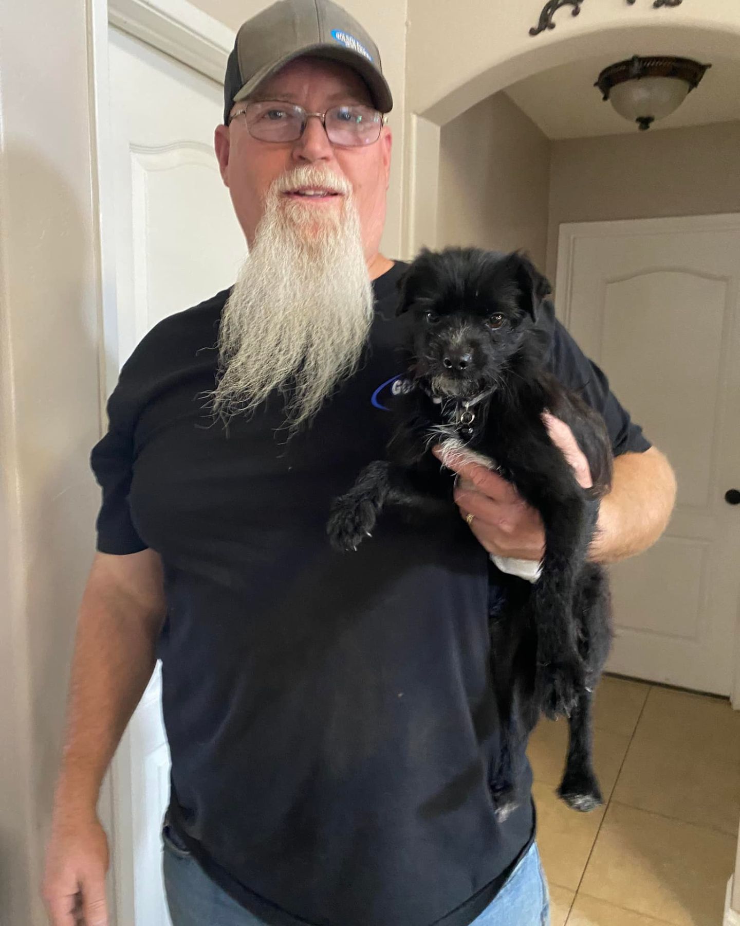 old man holding a dog