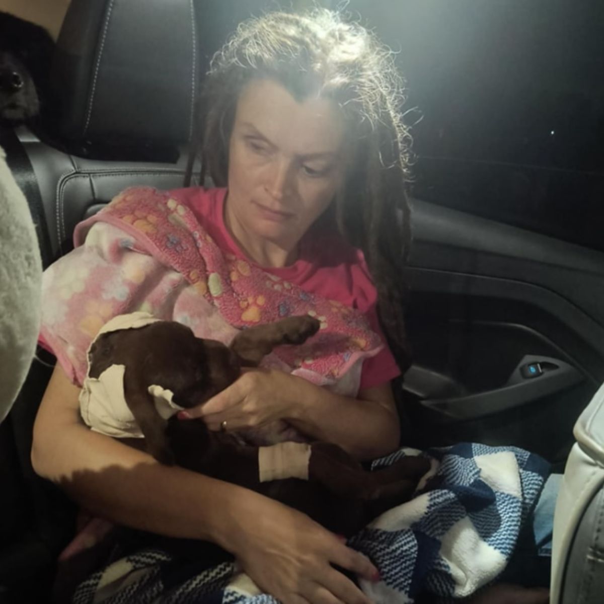 woman holding injured dog