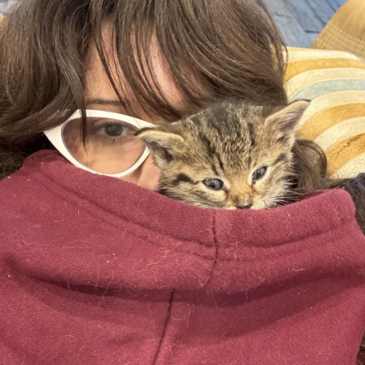 woman and tiny kitten