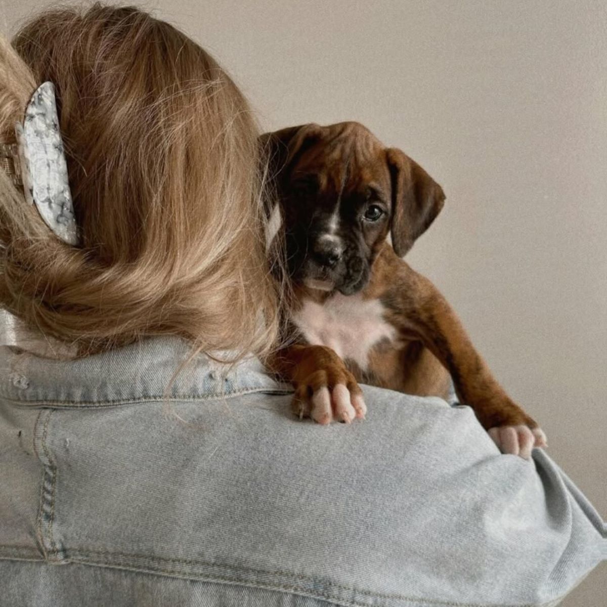 woman holding a puppy