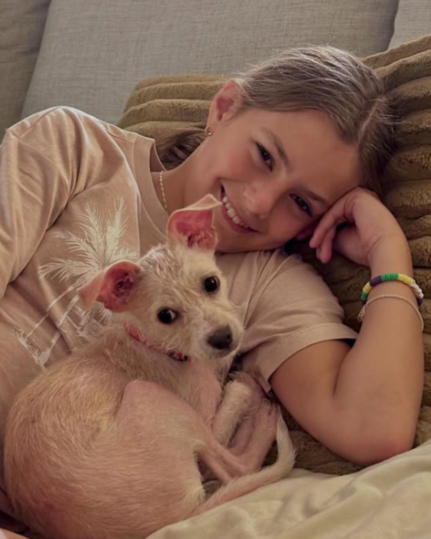 girl lying with puppy