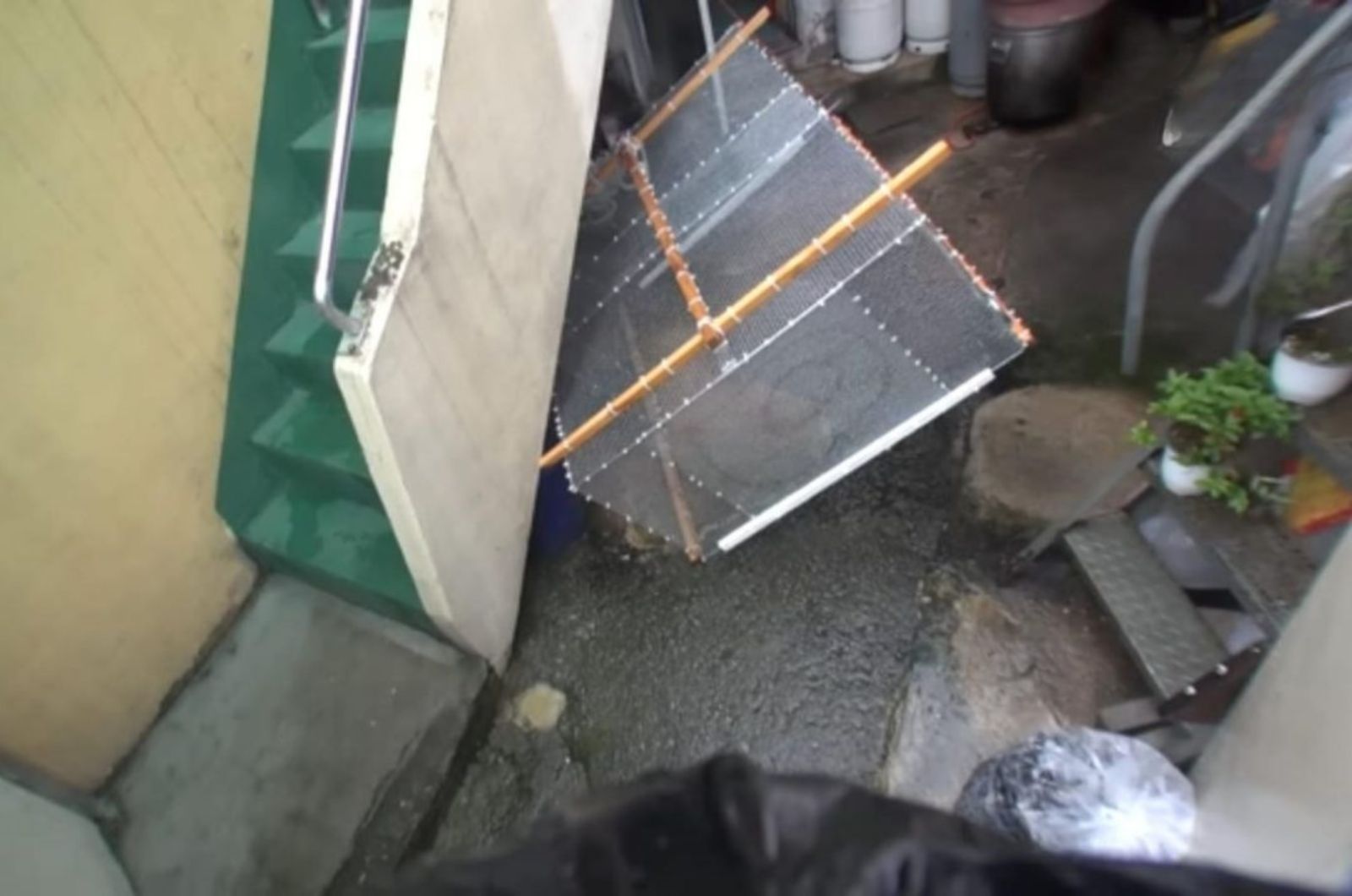 trash under stairs
