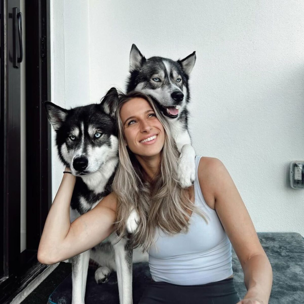 woman and huskies