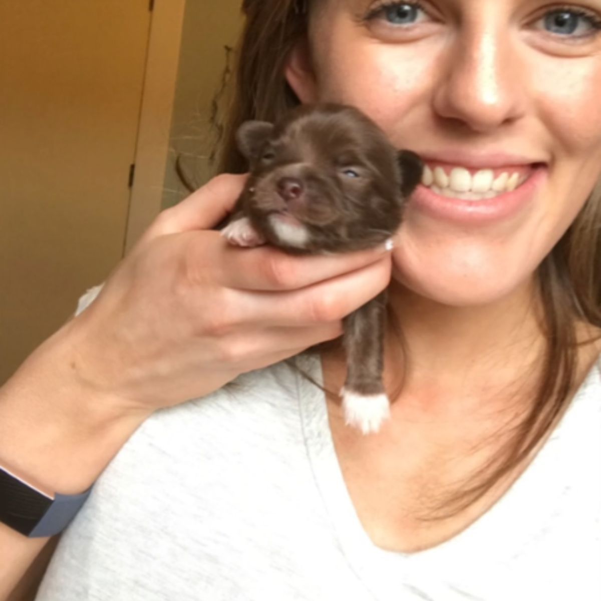 woman holding a puppy