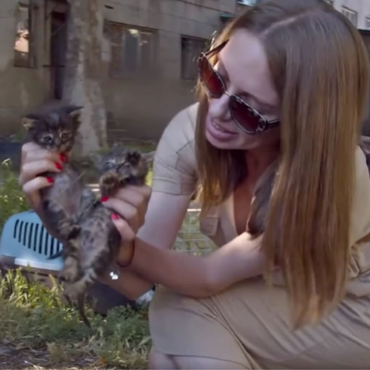 woman holding two kittens