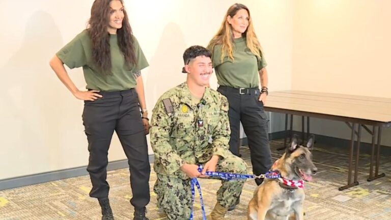 military dog with man and two women
