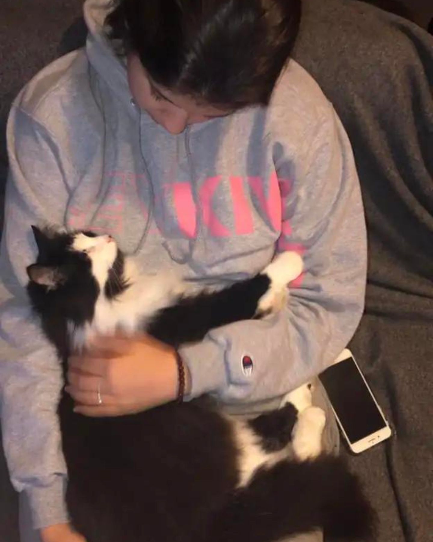 a girl cuddling her cat
