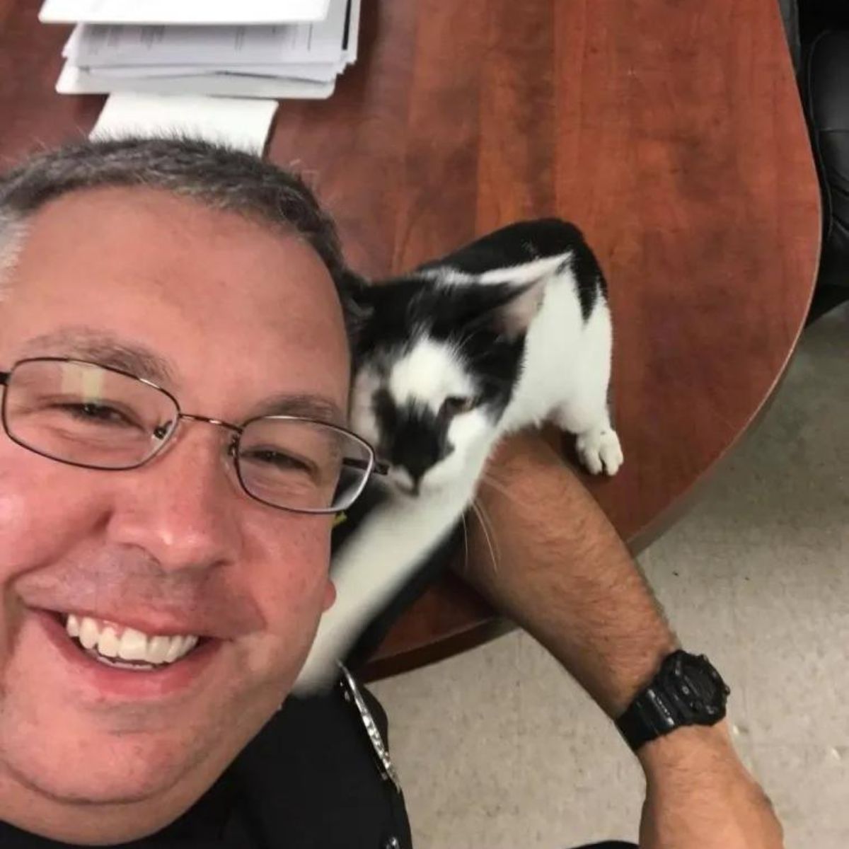 cat cuddles with the policeman