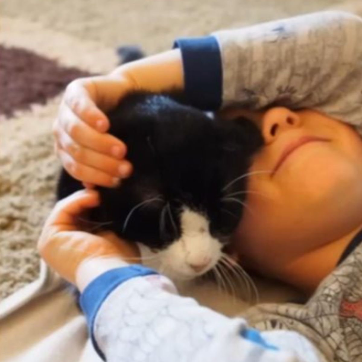 child lying with a cat
