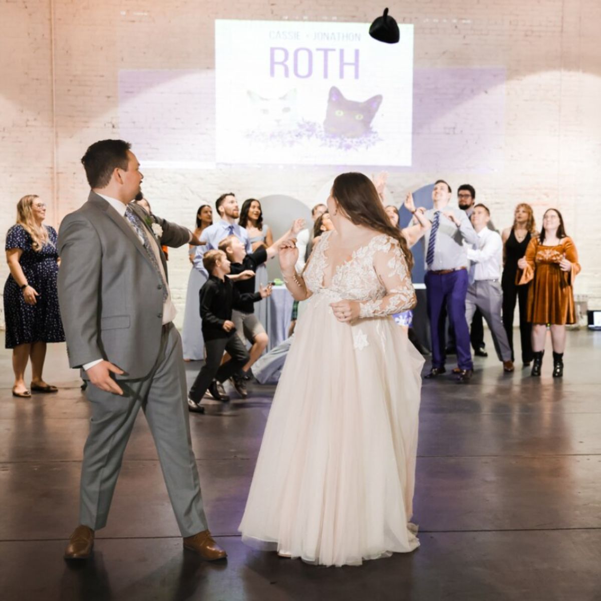 couple at a wedding with a picture of a cat in the background