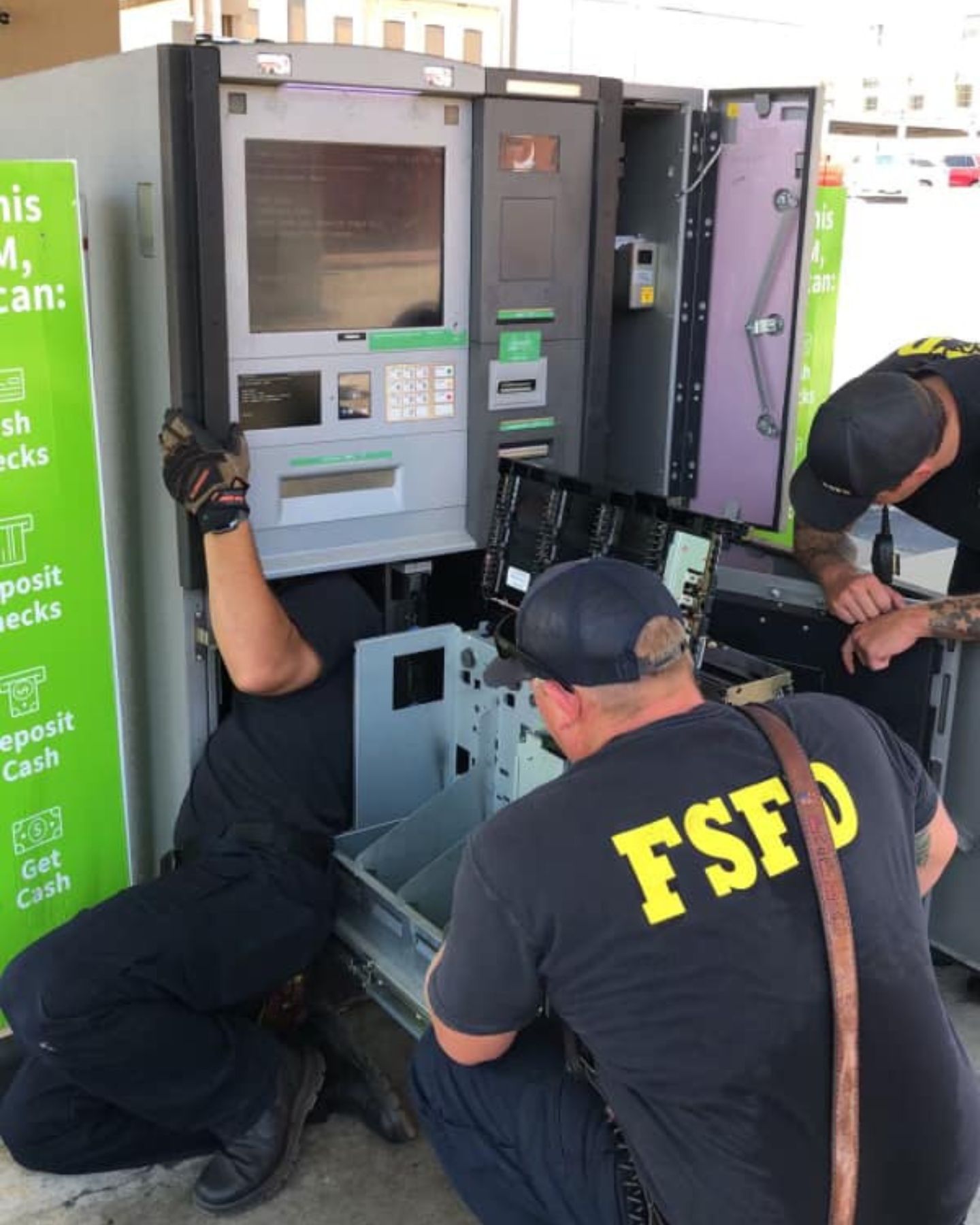 firefighters inspecting an ATM