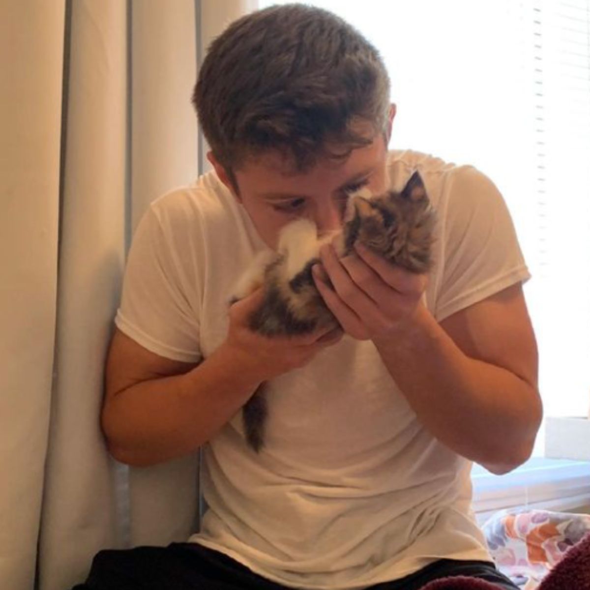 guy kissing little cat