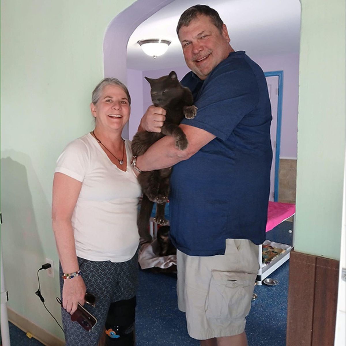 man and woman with a cat