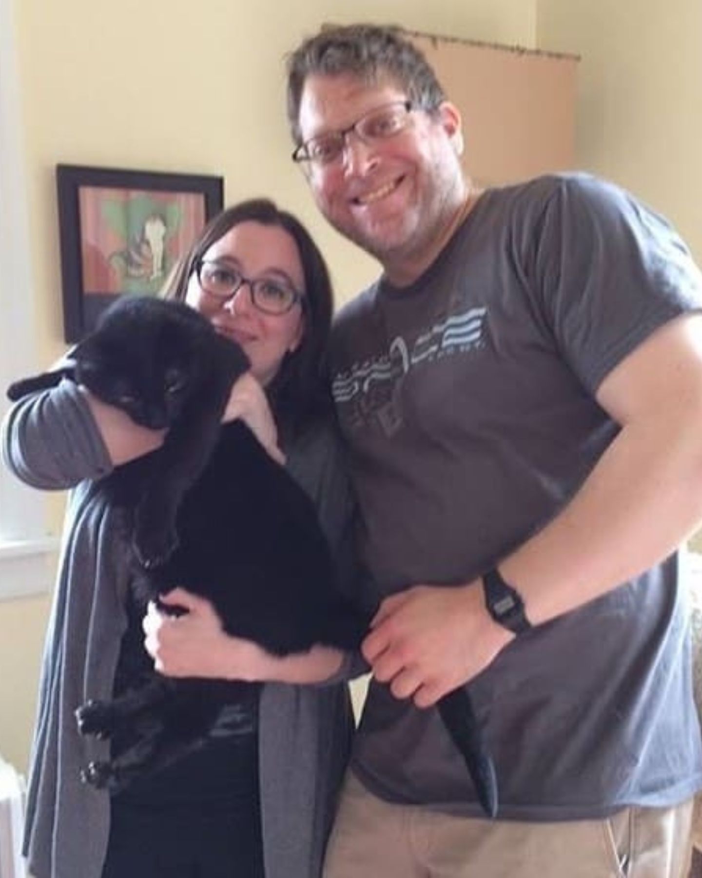 man and woman with a cat