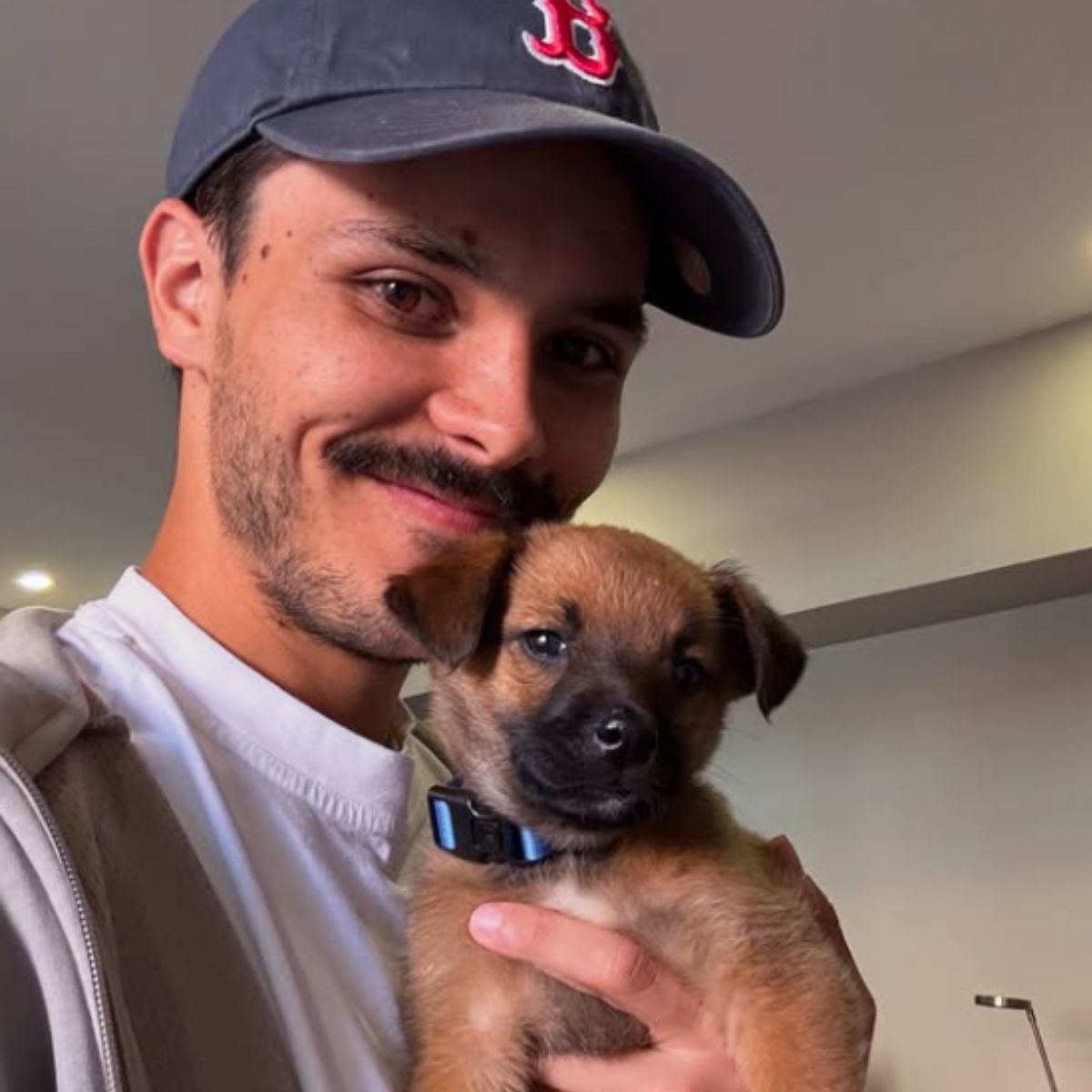 man holding a puppy