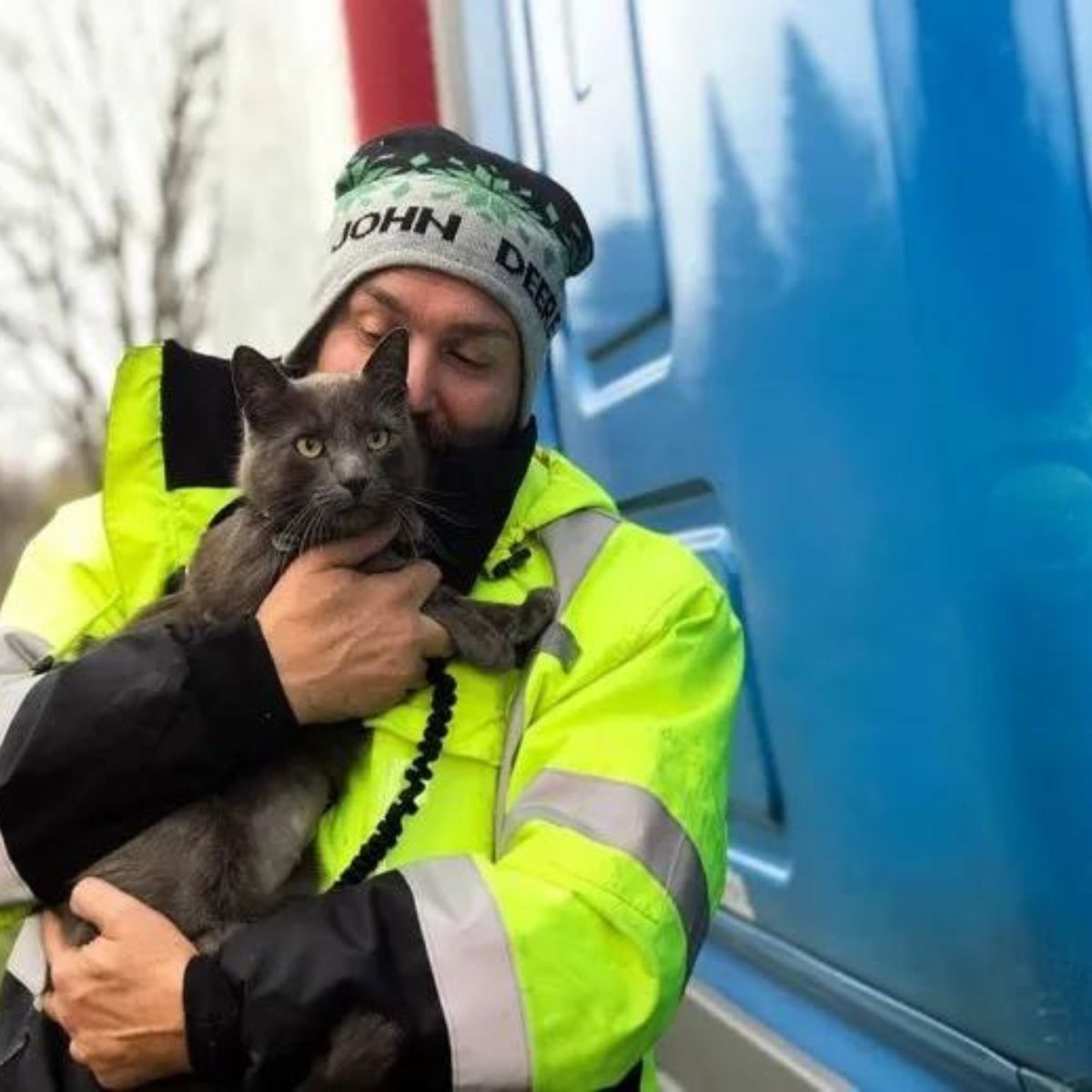 man hugging a cat