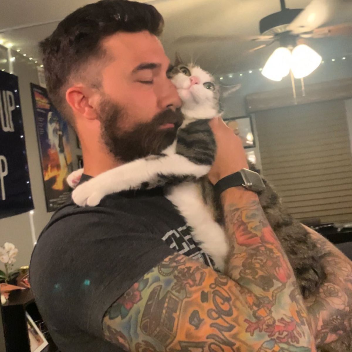 man hugging the cat