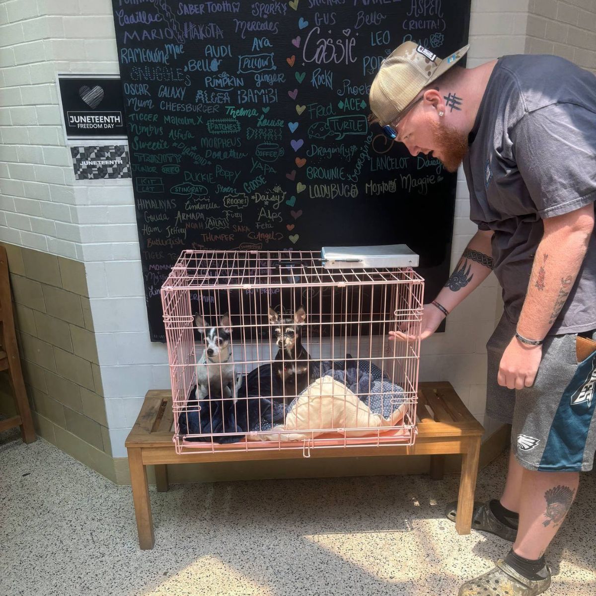 man standing next to a cage