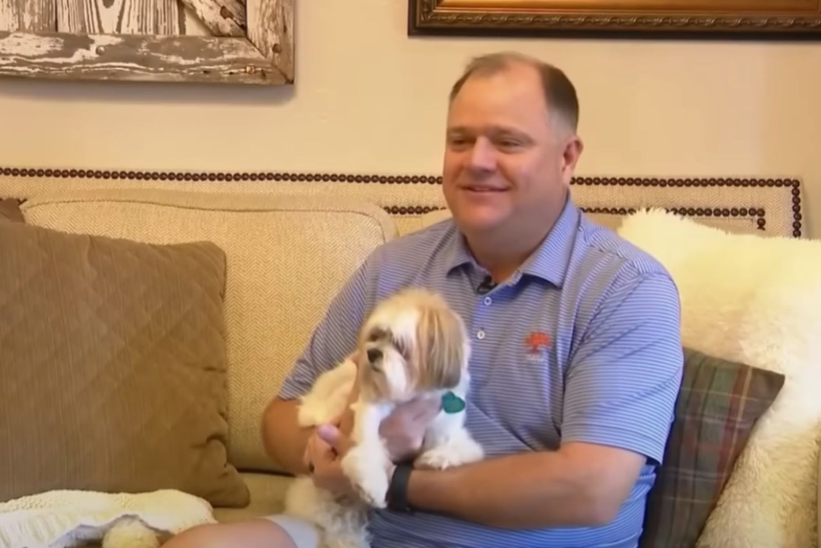 man with white small dog