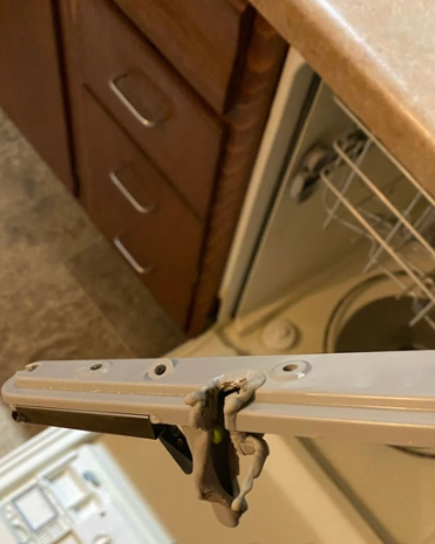 piece of plastic had fallen onto the heating element of the dishwasher and was melting away