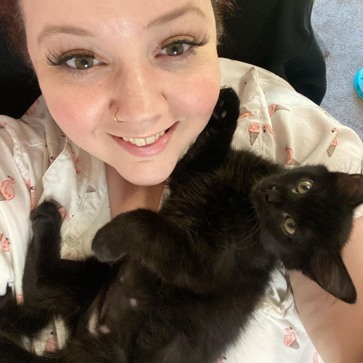 smiled woman with black kitten