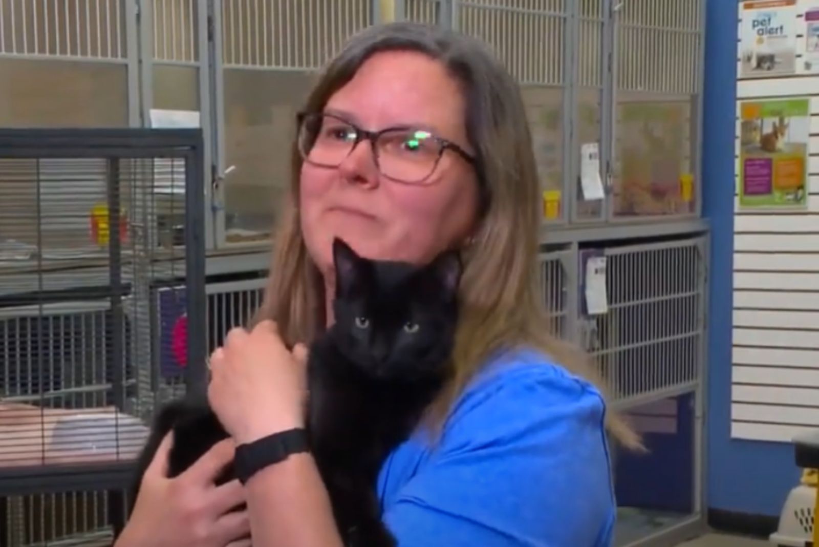 veterinarian cuddles with a small black cat