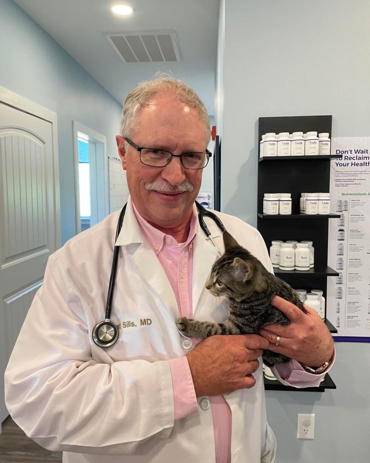 veterinarian with a kitten in her arms