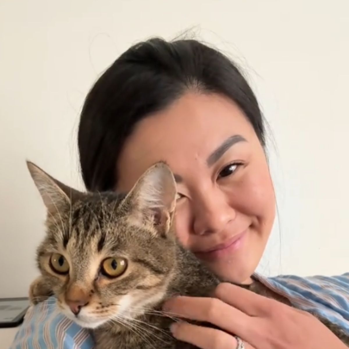 woman and cat cuddling