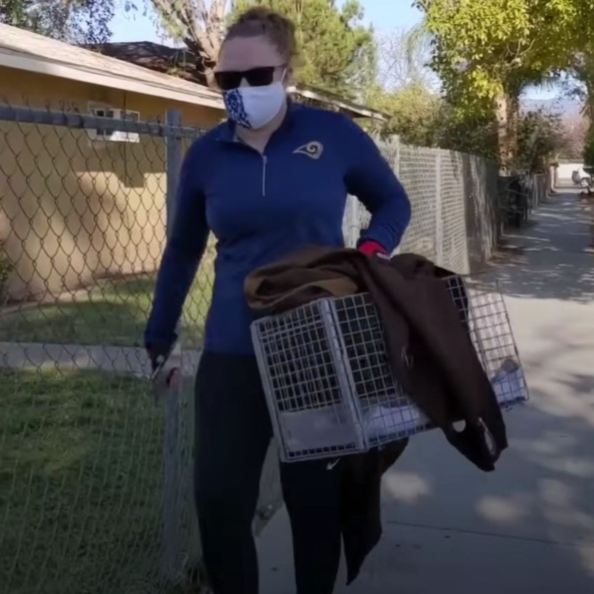 woman carrying a cat cage