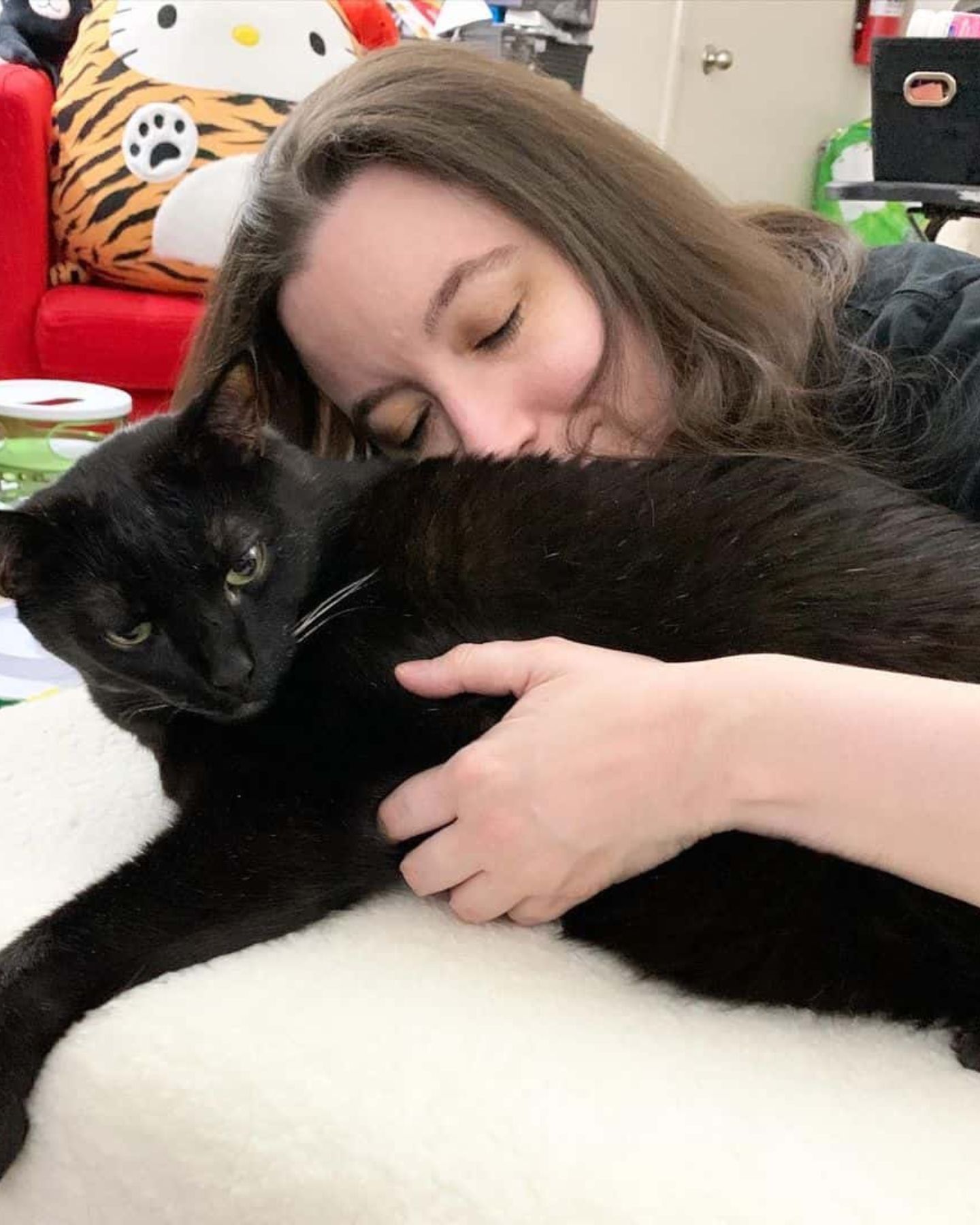 woman cuddling with a cat