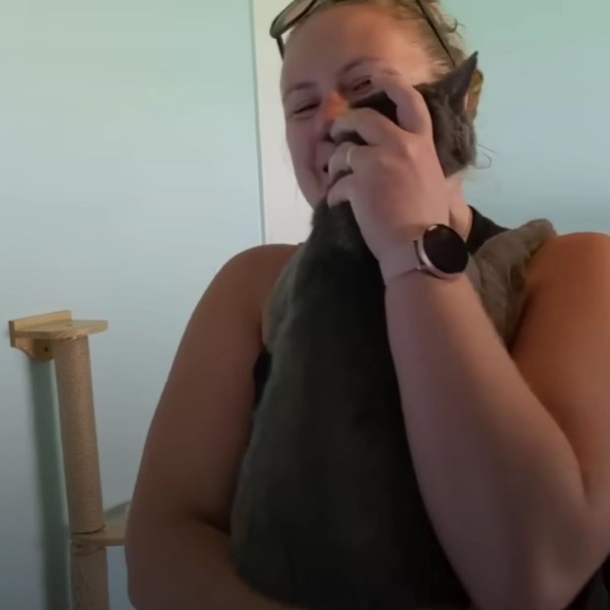 woman hugging a cat