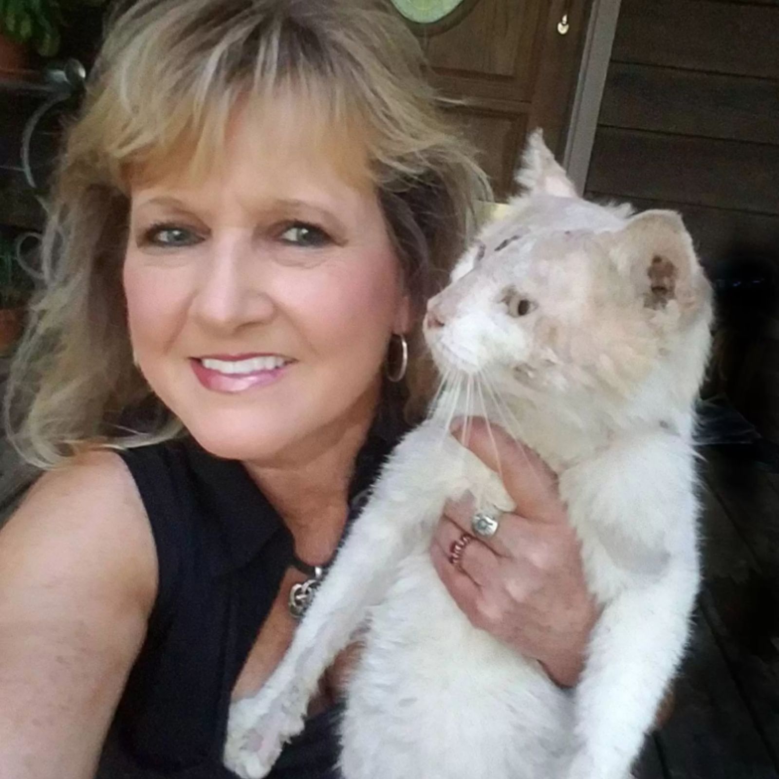 woman is holding a cat