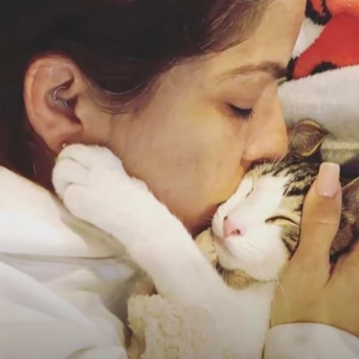woman is kissing the cat