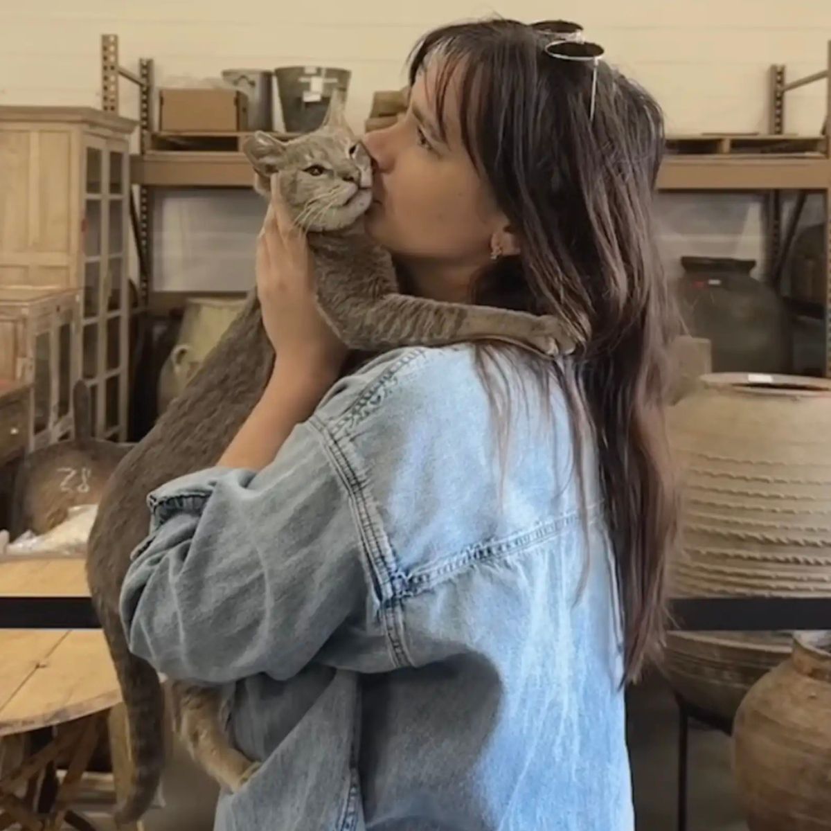 woman kissing a cat