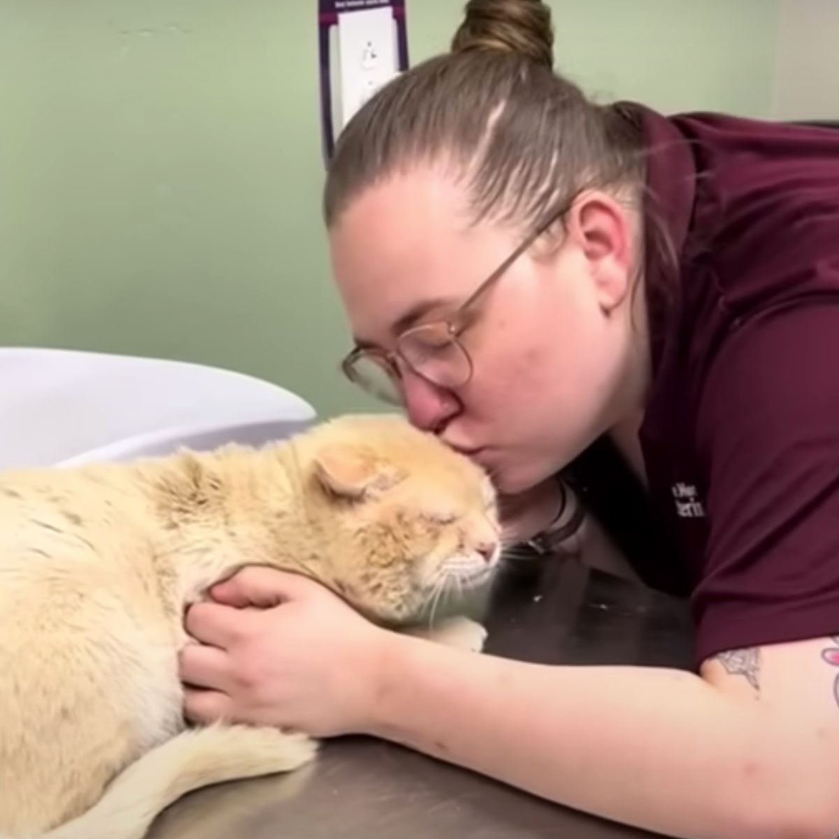 woman kissing the cat