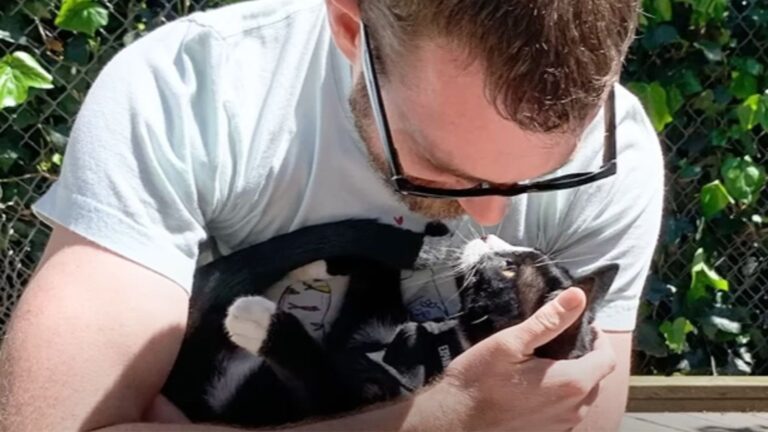 man hugging a cat