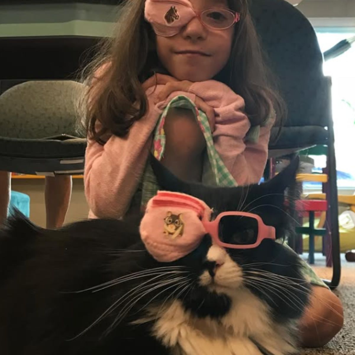 little girl and cat wearing glasses