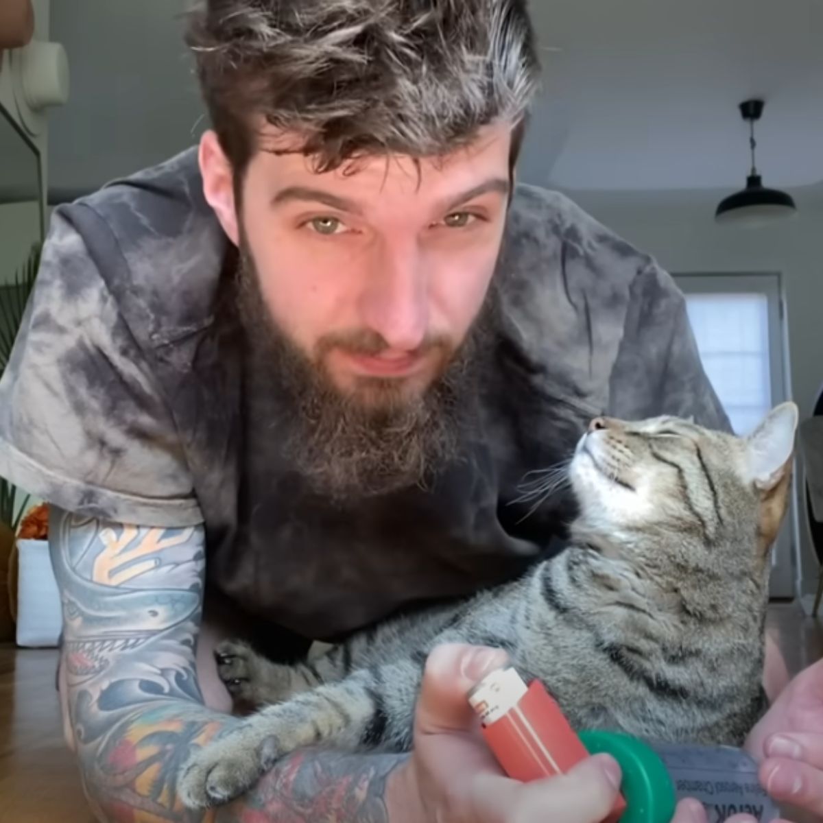 man and sick cat