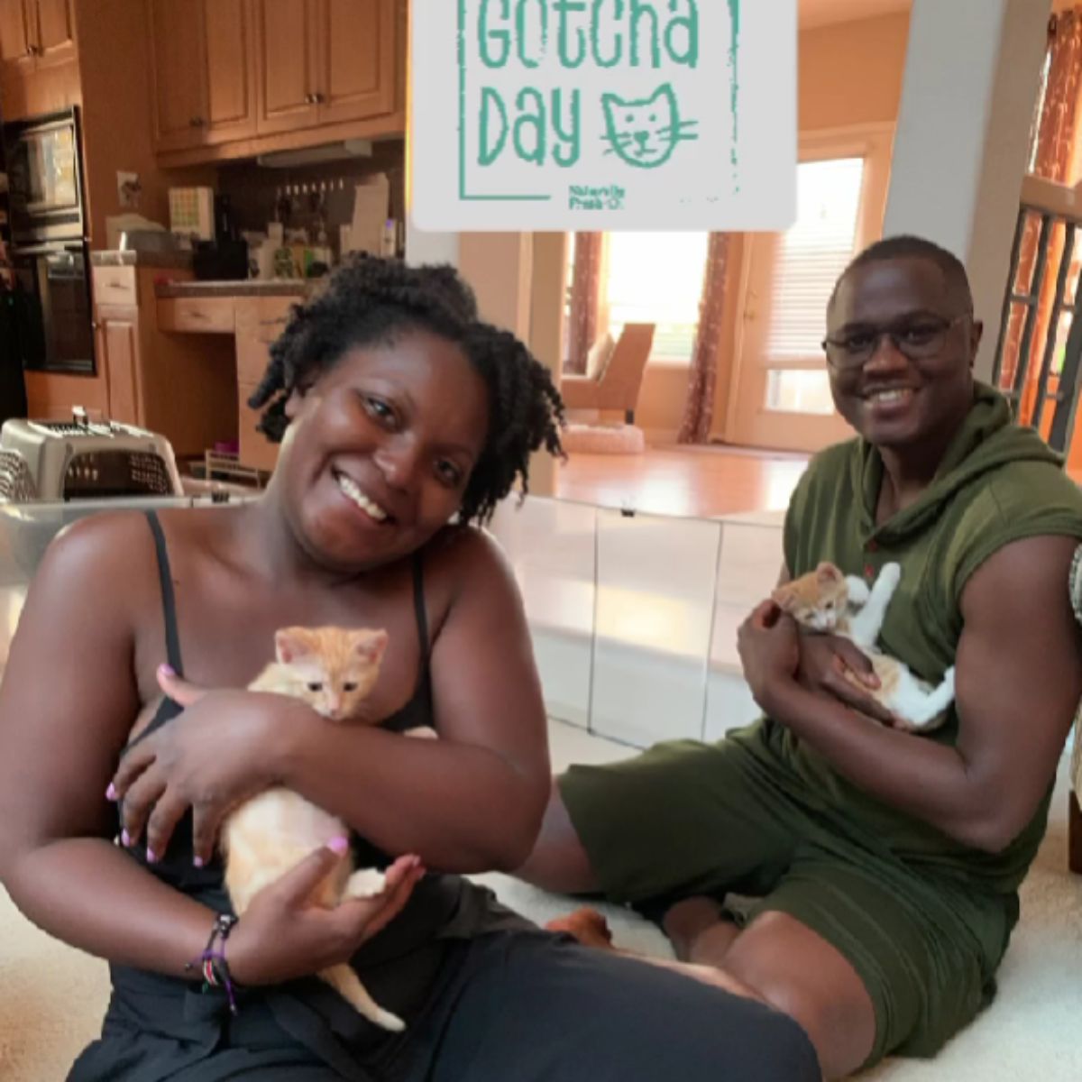man and woman each holding a kitten