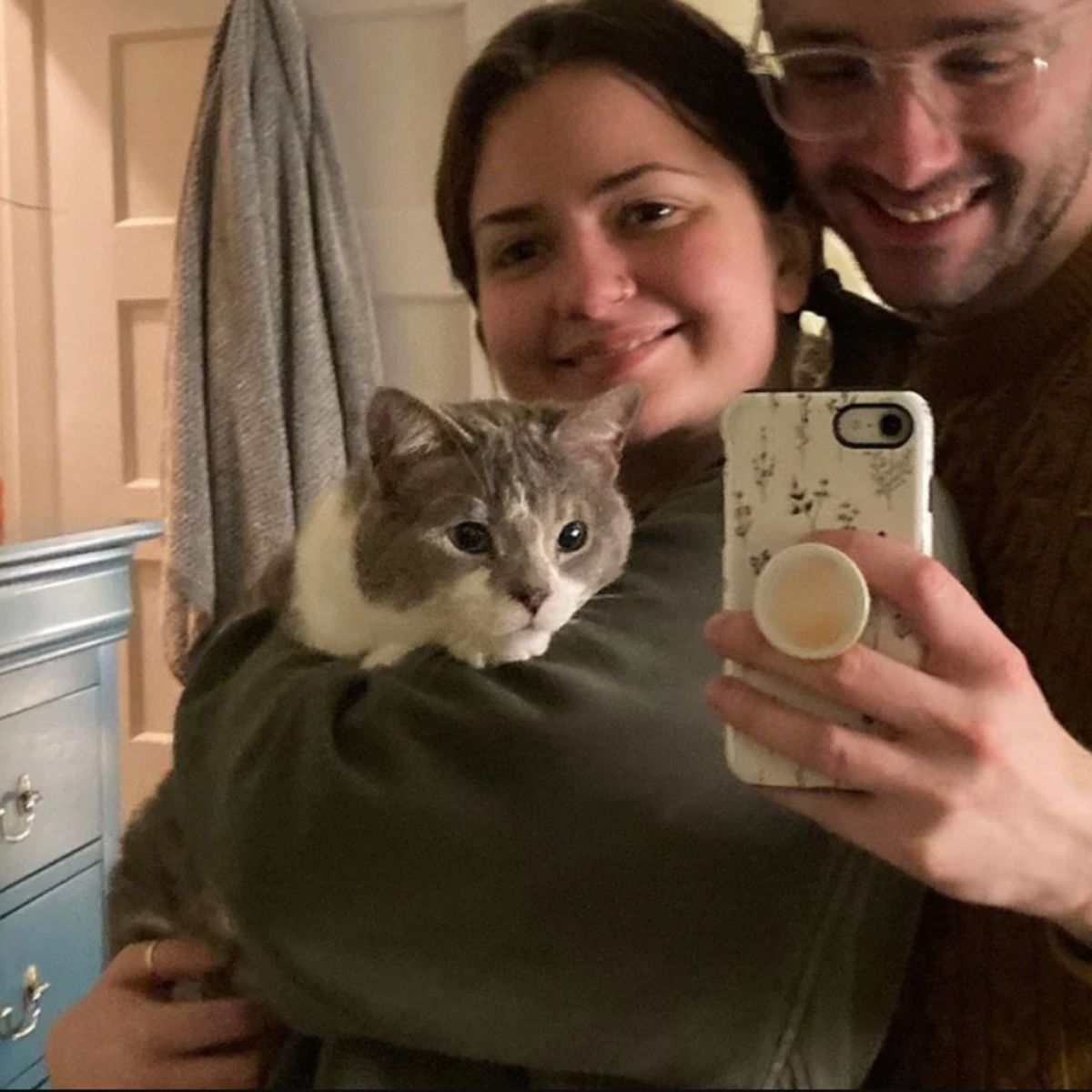 man and woman with a cat
